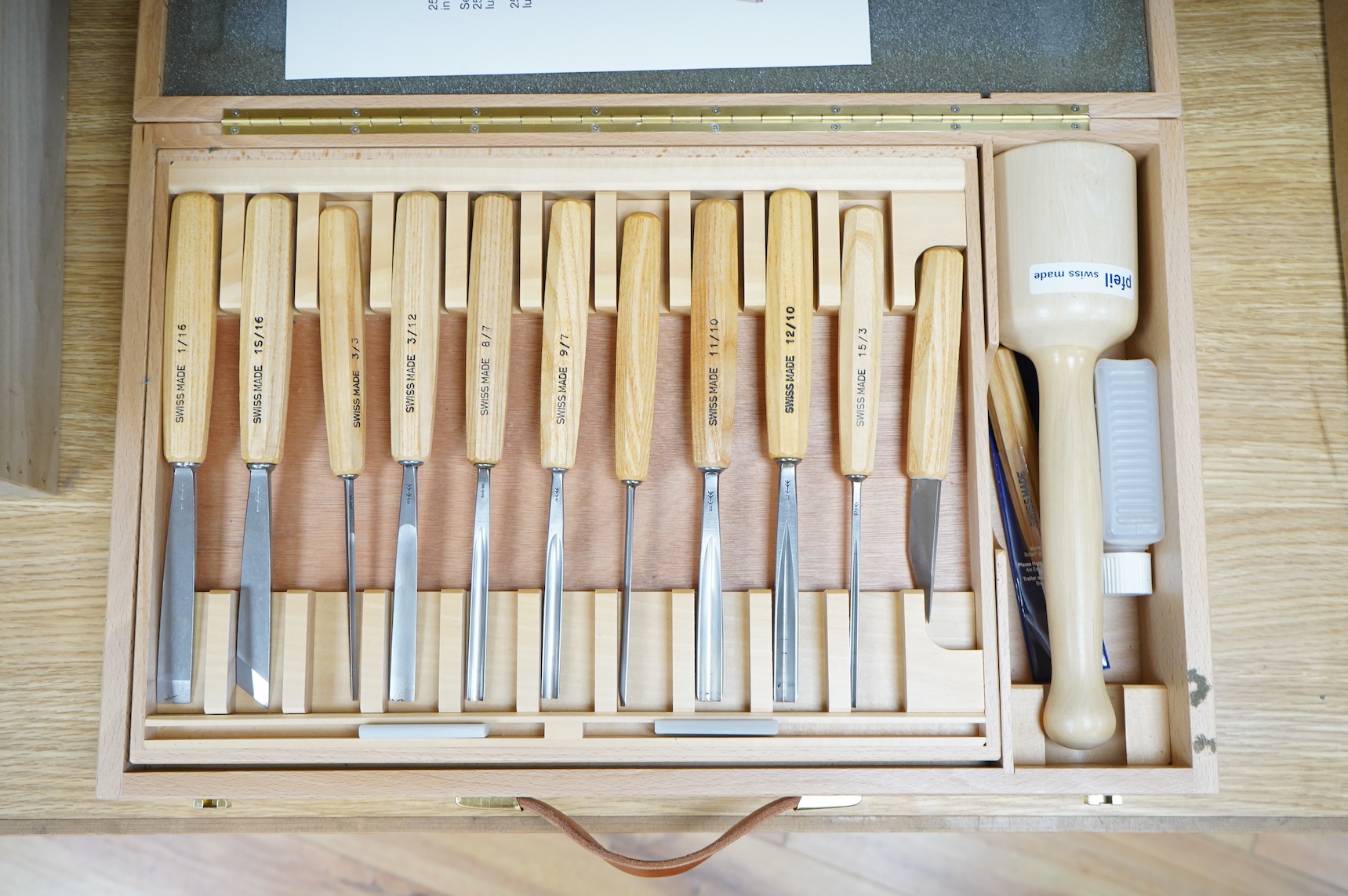 A Swiss made Pfeil 25-piece wood carving set, comprising; carving chisels, a mallet, sharpening stones, etc. contained within a fitted beech case, 530 x 330 x 95mm